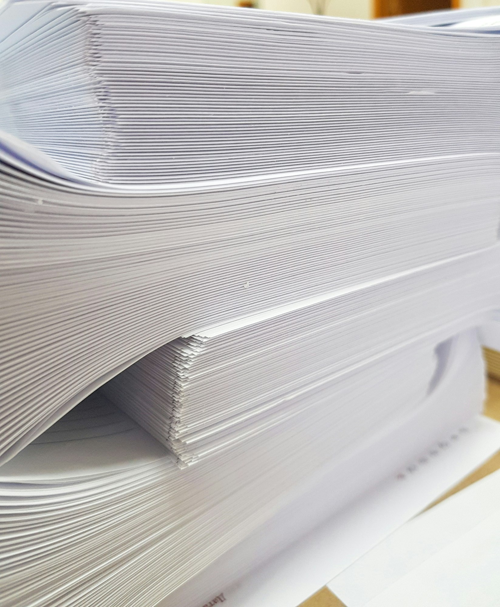 A stack of blank paper, book blocks prepared for binding in a printing house